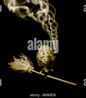 merry witch flying on broom and smoke pipe Stock Photo