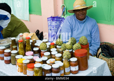 Mauritius, Port Mathurin. Woman selling preserves and bottled pickles for sale Stock Photo