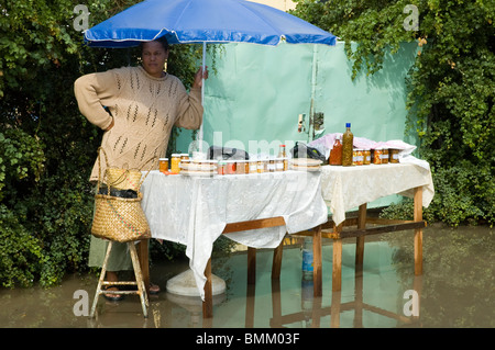 Mauritius, Port Mathurin. Woman selling preserves and bottled pickles for sale Stock Photo