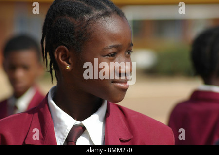 Nigeria, Jos, profile Portrait of a schoolgirl with traditional african plaits, Stock Photo