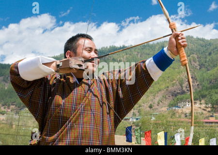 Young man is aiming with bow and arrow, Thimpu, Bhutan, Asia Stock Photo