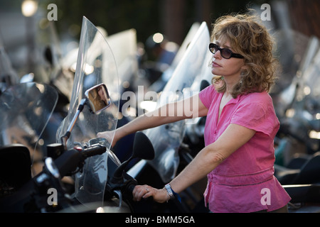 A young woman and Piaggio - Vespa scooters, Rome, Italy Stock Photo
