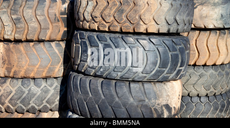 Piles of used front loader tyres Stock Photo