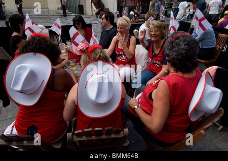 Middle aged female football fans in England at a pub in Brighton, wearing team colours and flags. Stock Photo