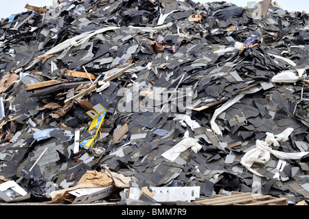 Big pile of asphalt roofing shingles and trash at landfill Stock Photo