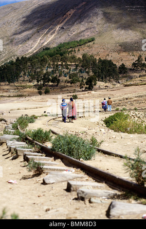 People walking along the disused railway line from Tarabuco near sucre in Bolivia Stock Photo