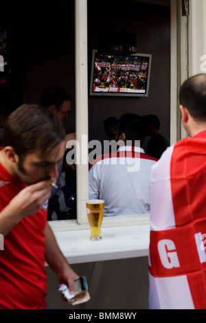 England World Cup football fans watch their team's opening match on TV in Soho. Stock Photo