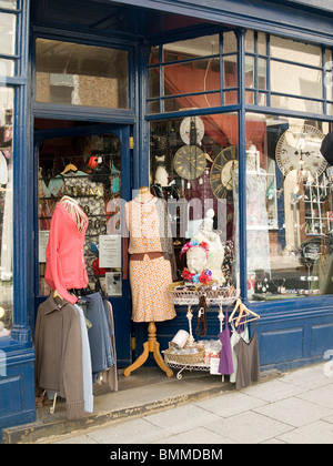 Doorway of an antique and curio shop with elegant clothing on dressmakers dummies Stock Photo