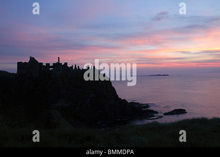 sunset at Dunluce Castle, coast of Antrim, Northern Ireland Stock Photo