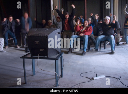 A group of workers in a construction site watch a football match, Buenos Aires, Argentina Stock Photo