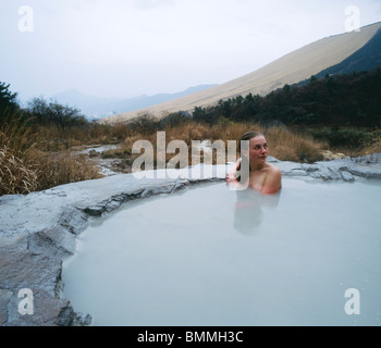Girl bathing in Nabe-yama-no-yu outdoor mud onsen hot spring. Beppu ...