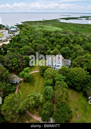 A view of the Currituck Beach Light Station keeper's house and the Atlantic Ocean from the observation deck of the lighthouse. Stock Photo