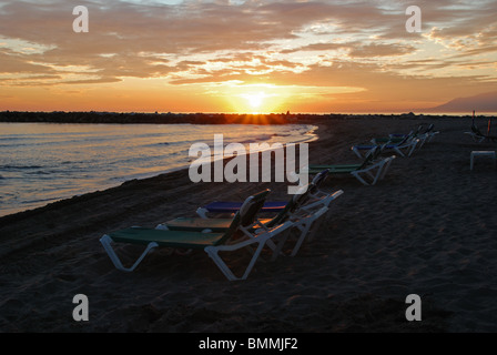 Sun loungers on the beach at sunset, Puerto Cabopino, Marbella, Costa del Sol, Malaga Province, Andalucia, Spain, Europe. Stock Photo