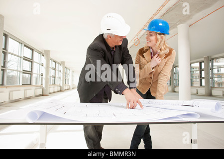 Two architects checking plans of site Stock Photo