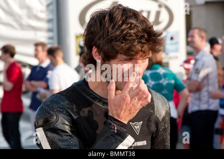 Guy Martin at the 2010 Isle of Man TT picking his nose the week before his explosive accident. Stock Photo