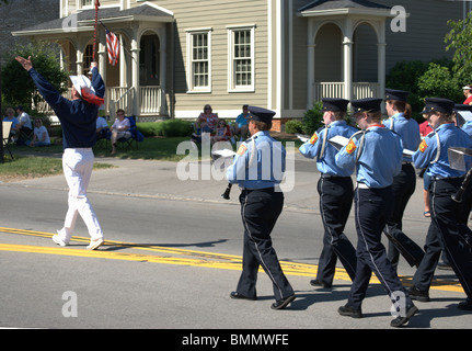 Band leader leads band of Firemen in Memorial Day parade in small town USA. Stock Photo