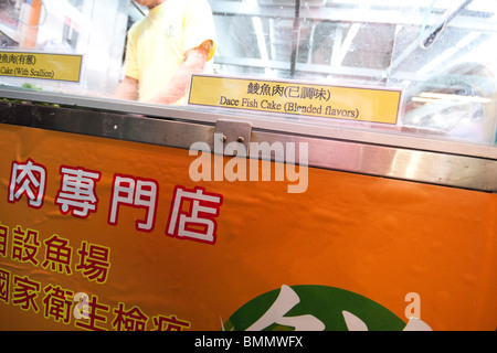 Man in shop selling dace fish cake food in hong Kong Stock Photo