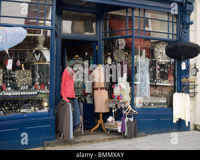 Doorway of an antique and curio shop with elegant clothing on dressmakers dummies Stock Photo