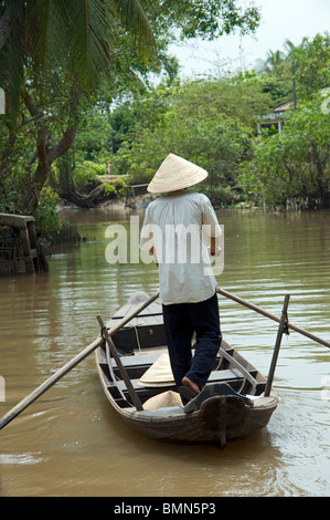 A Vietnamese man is rowing his boat. Mekong Delta River tour, Vietnam ...