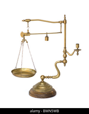 Vintage brass scale with weight, pan, and candle holder isolated. Used for display or decoration as a unique vintage antique. Stock Photo