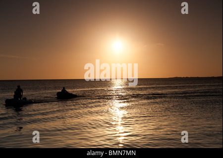 Boats on sea at sunset in Bonaire in Caribbean Stock Photo