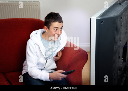 Young fan watching football or soccer on tv Stock Photo