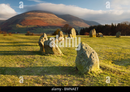 A cloud-shrouded Blencathra stands vigil over the ancient Castlerigg Stone Circle near Keswick in the Lake District of England Stock Photo