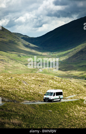 Mountain Goat minibus tour on Hardknott Pass looking at Wrynose Valley The Lake District England UK Stock Photo