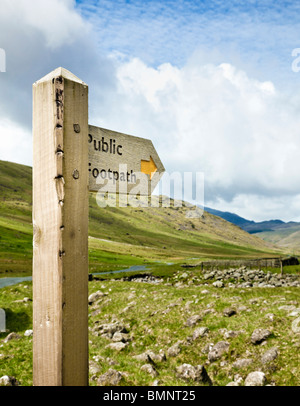 Public footpath wooden signpost in a remote valley in The Lake District England UK Stock Photo