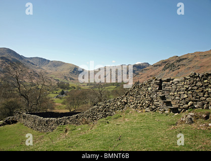 Stile in a dry stone wall looking towards Great Langdale Fells near to Elterwater, Lake District National Park Cumbria England Stock Photo