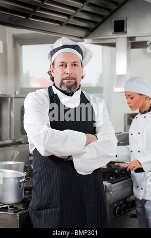 portrait of confident chef looking at camera in kitchen Stock Photo