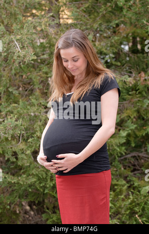 Happy young woman pregnant in the ninth month Stock Photo
