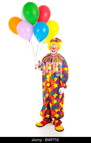 Full body isolated view of a happy clown holding a bunch of colorful balloons. Stock Photo