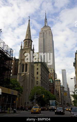 Looking up 5th Avenue past Marble Collegiate Church to the Empire State Building at 34th Street. in NYC Stock Photo