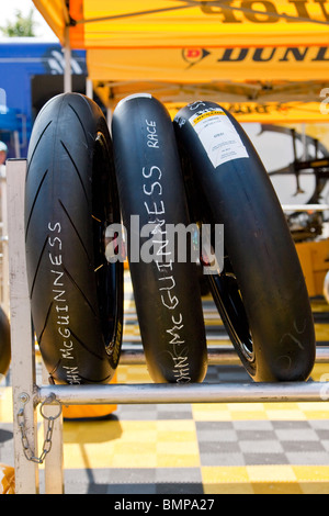 John McGuinness's racing Dunlop tires on wheels ready for race day at Isle of Man 2010 TT Stock Photo