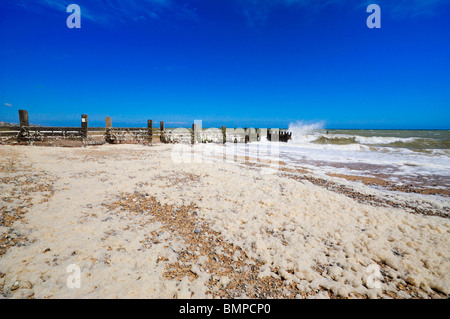 Sea Foam on Walcot Beach, Norfolk  UK Stock Photo