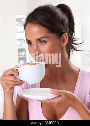 WOMAN DRINKING CAPPUCCINO