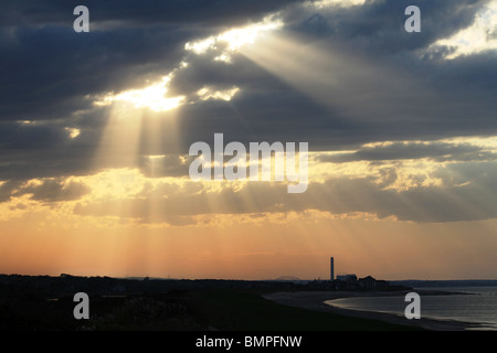 Crepuscular rays, in atmospheric optics, are rays of sunlight that appear to radiate from a single point in the sky. Stock Photo