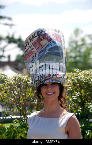 A lady at the Royal Ascot race meeting wearing a hat made from the Racing Post newspaper Stock Photo