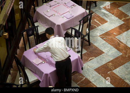 A waitperson sets a table in a Chinese restaurant in the World Financial Center in New York Stock Photo