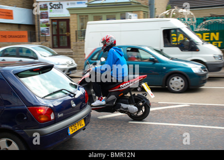 Moped rider in Lockwood, Huddersfield. Stock Photo