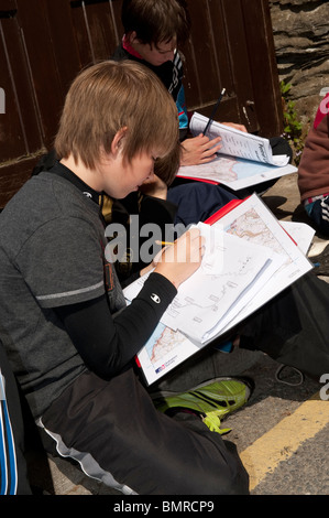 Primarty schol children doing a survey of the village at The Urdd Centre, Llangrannog, Ceredigion, West Wales UK Stock Photo