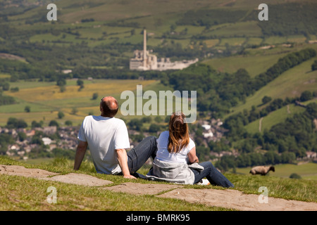 UK, Derbyshire, Peak District, couple enjoying view over Hope cement works from Mam Tor Stock Photo