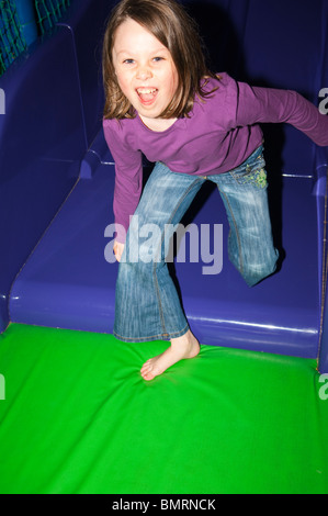 A MODEL RELEASED picture of a girl ( 8 ) on indoor play apparatus in the Uk Stock Photo