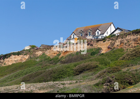 buildings on the cliff edge at Barton on Sea in Hampshire in danger of falling into the sea due to costal erosion Stock Photo