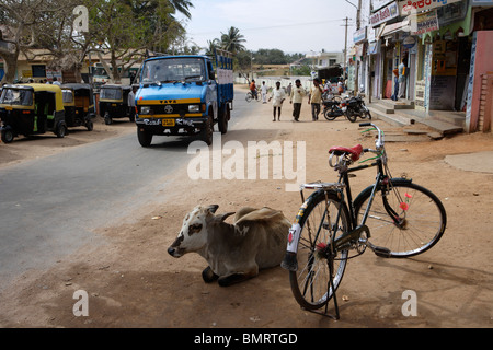 Cow Seated On Road, Fruits Stall, Kamalapur, Hampi, Deccan Plateau, Taluka Hospet, District Bellary, State  Karnataka, India Stock Photo