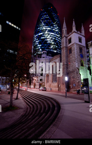 Swiss RE building at 30 St Mary Axe in the City of London as seen from Leadenhall Street at night. Stock Photo