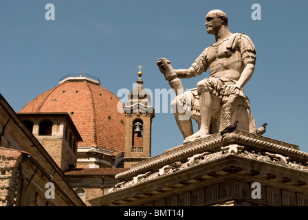 Basilica of San Lorenzo, Florence. Statue of Giovanni de Medici (Giovanni delle Bande Nere) by Bandinelli in the front Stock Photo