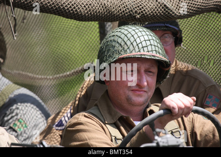 Soldiers riding in a jeep camouflaged Stock Photo