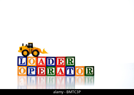 Colorful children's blocks spelling LOADER OPERATOR with a model loader earth moving machine Stock Photo